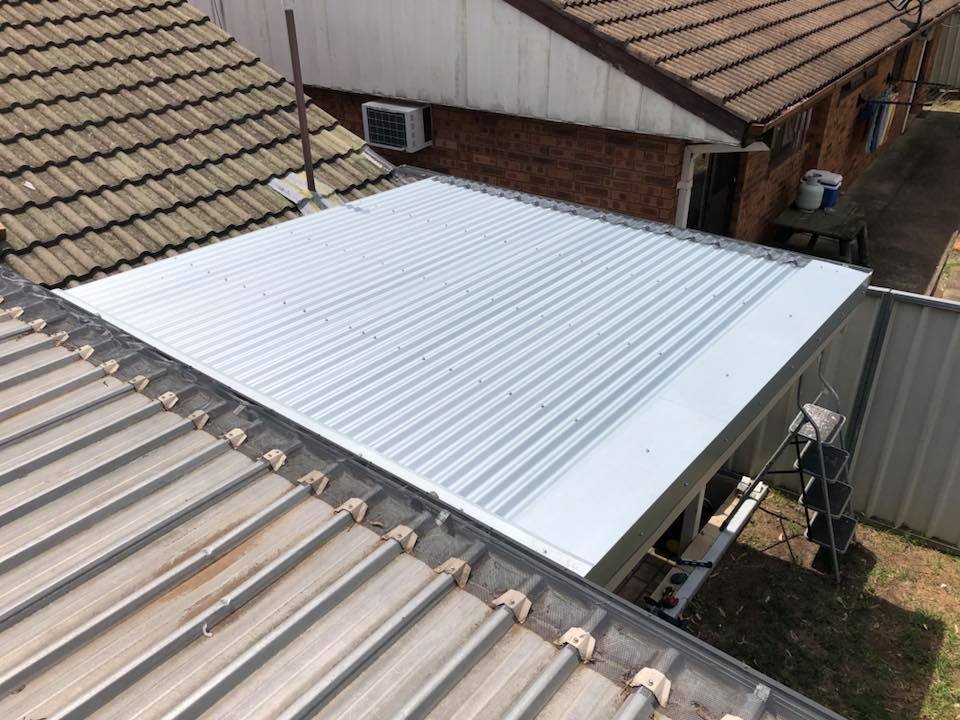 After: new pale metal sheets on the same patio roof
